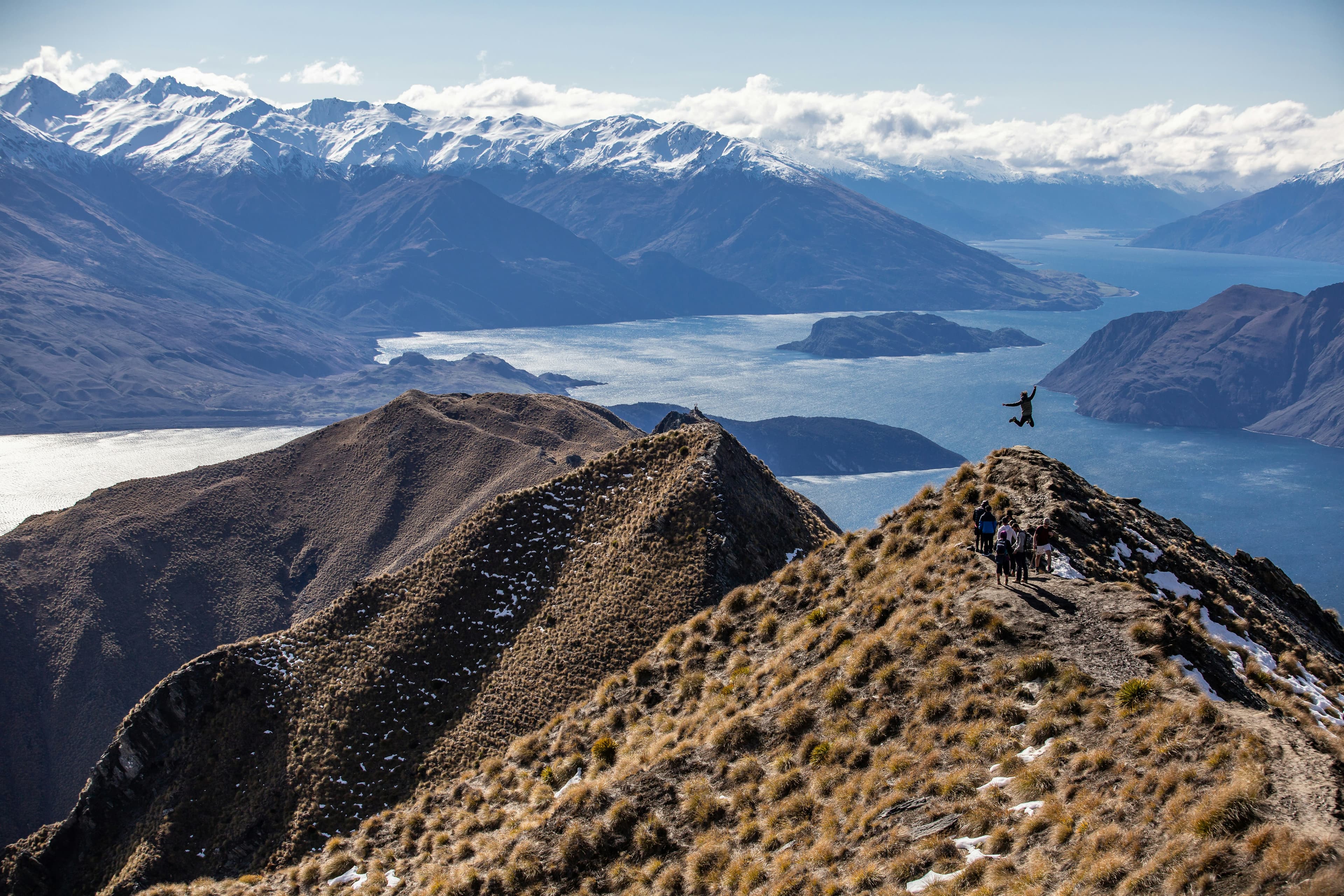 Hiker jumping for joy in Wanaka valley
